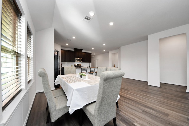 dining space with dark hardwood / wood-style flooring