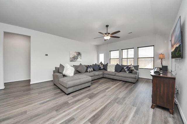 living room with light hardwood / wood-style floors and ceiling fan