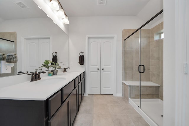 bathroom with an enclosed shower, vanity, and tile patterned floors