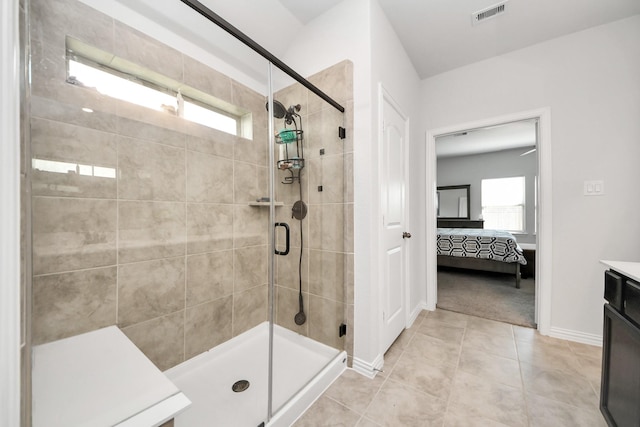 bathroom featuring tile patterned flooring, vanity, and a shower with door