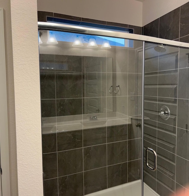 bathroom with a shower with door