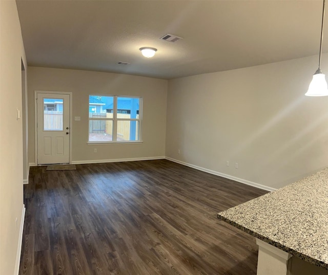 unfurnished living room with dark hardwood / wood-style floors