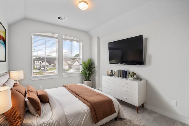 carpeted bedroom featuring vaulted ceiling