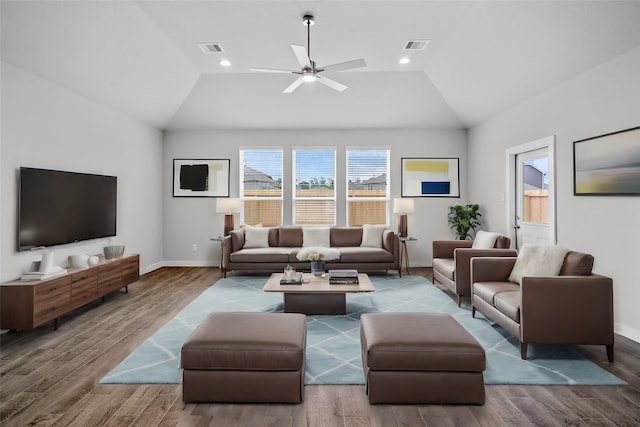 living room with ceiling fan, wood-type flooring, and vaulted ceiling