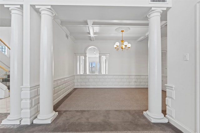 carpeted spare room featuring a chandelier, beam ceiling, and coffered ceiling