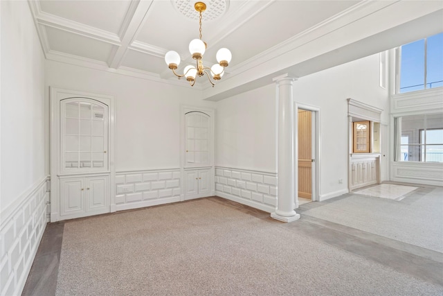 unfurnished room with coffered ceiling, carpet floors, ornamental molding, a chandelier, and beamed ceiling