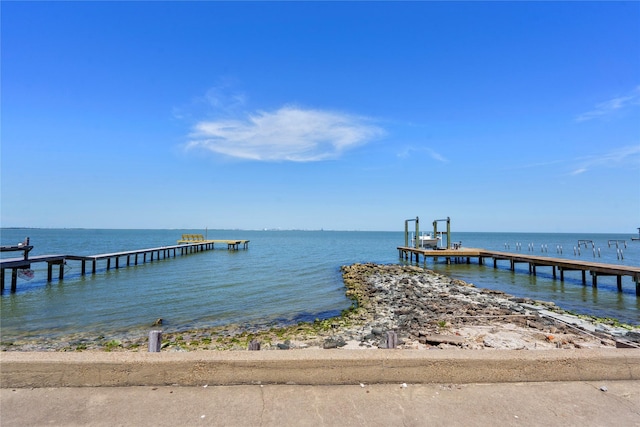 dock area with a view of the beach and a water view