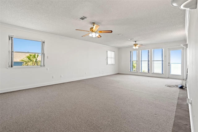 carpeted empty room with a textured ceiling, ceiling fan, and crown molding