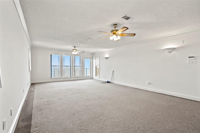 carpeted spare room featuring ceiling fan, a textured ceiling, and crown molding