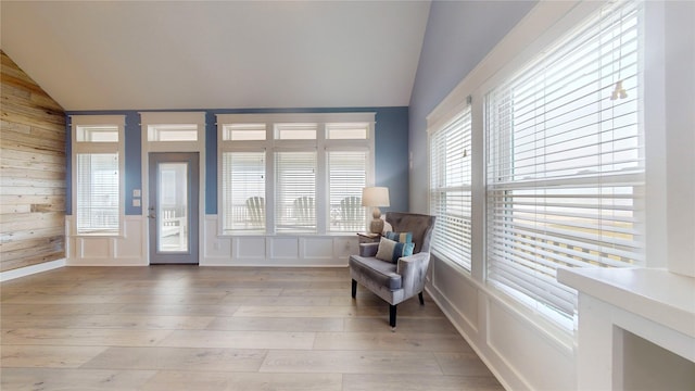 sitting room with vaulted ceiling and light hardwood / wood-style flooring