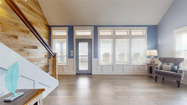 entrance foyer featuring hardwood / wood-style flooring and vaulted ceiling