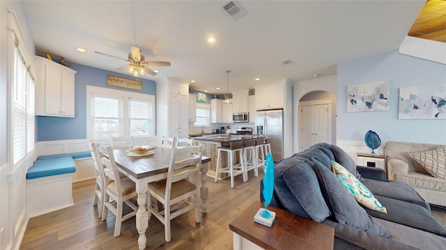 dining space featuring light hardwood / wood-style floors and ceiling fan