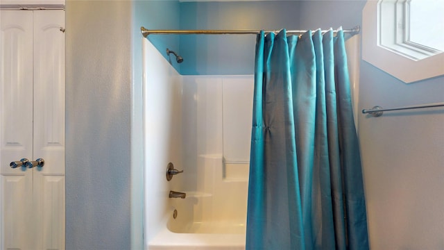 bathroom with shower / bath combination with curtain