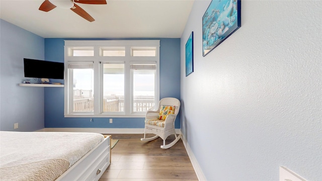 bedroom with ceiling fan and wood-type flooring