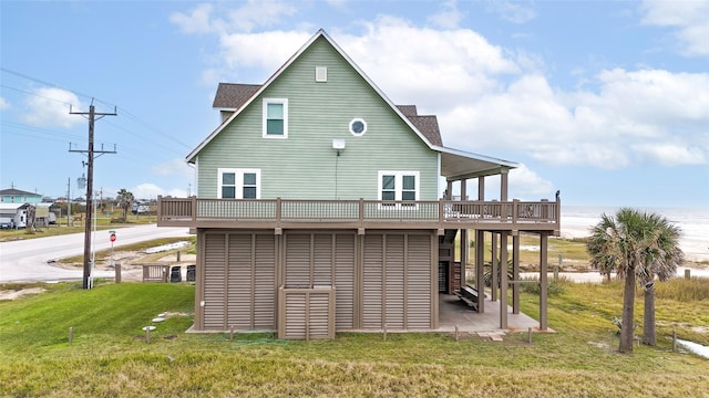 rear view of property with a lawn and a wooden deck