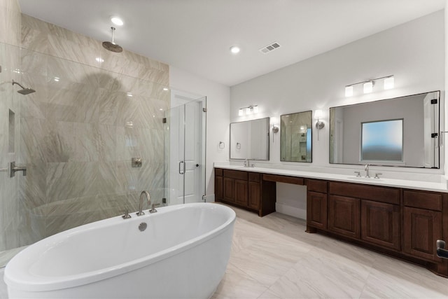 bathroom featuring vanity and separate shower and tub