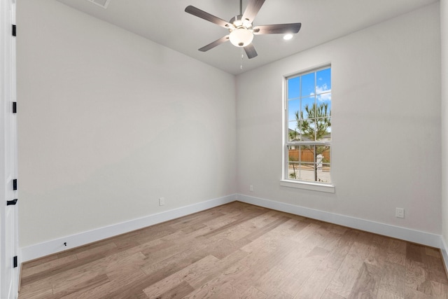 unfurnished room featuring baseboards, a ceiling fan, and light wood-style floors