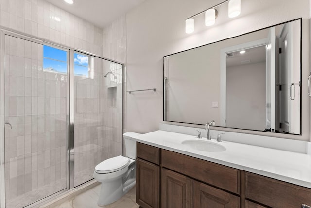 full bath featuring a stall shower, vanity, and toilet