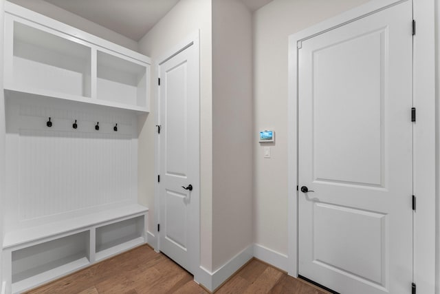 mudroom featuring light wood-style flooring and baseboards