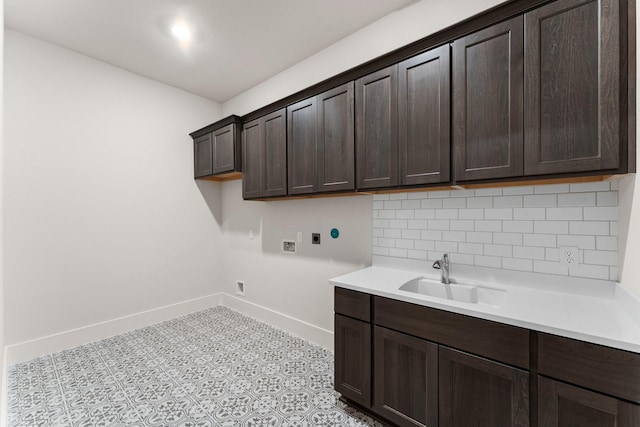 laundry room featuring hookup for a washing machine, a sink, baseboards, cabinet space, and electric dryer hookup