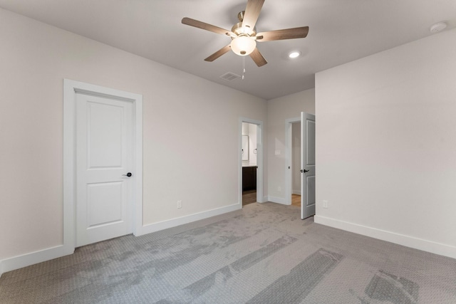 unfurnished bedroom with ceiling fan, connected bathroom, and light carpet