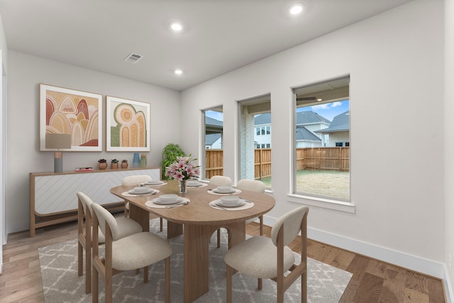 dining area with light wood-style flooring, visible vents, baseboards, and recessed lighting