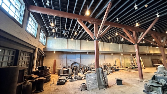 interior space with concrete floors and a high ceiling