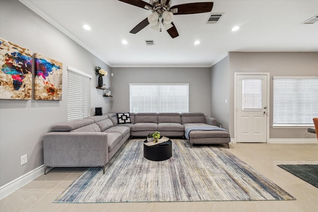 living room featuring ceiling fan, light tile patterned floors, and crown molding