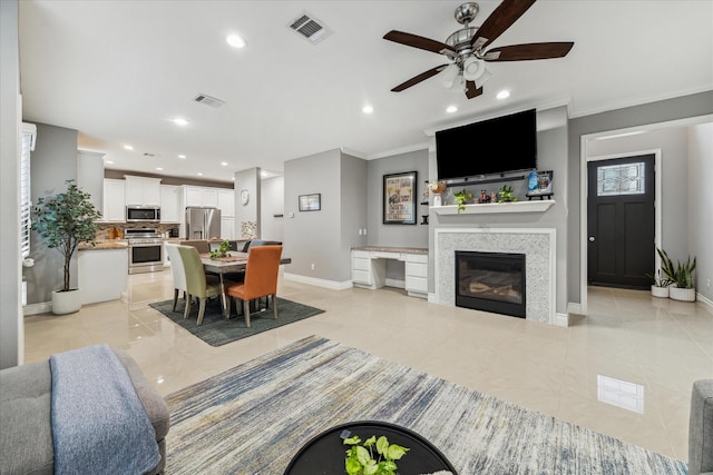 living room featuring ceiling fan and ornamental molding