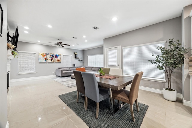 tiled dining area featuring ceiling fan and a wealth of natural light