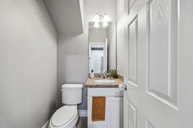 bathroom featuring toilet and vanity