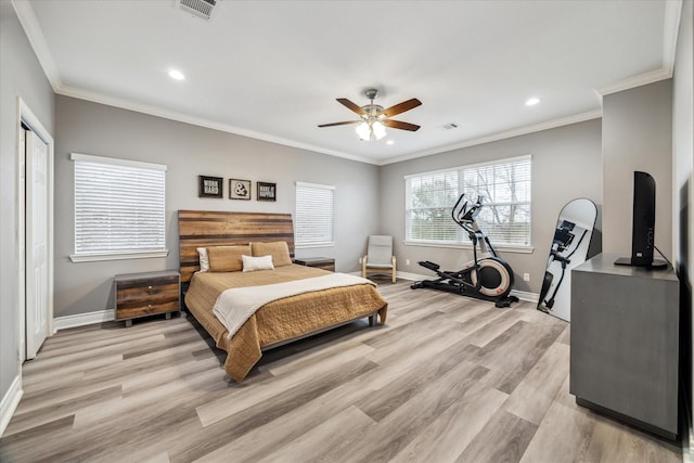 bedroom with ceiling fan, ornamental molding, and light hardwood / wood-style floors