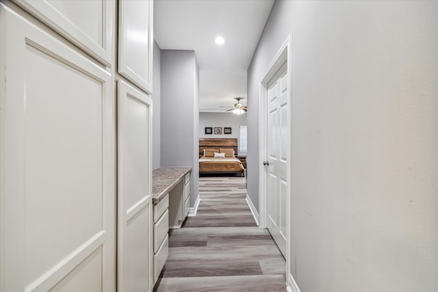 corridor with light hardwood / wood-style floors