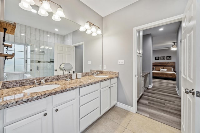 bathroom with vanity, ceiling fan, tile patterned flooring, and an enclosed shower