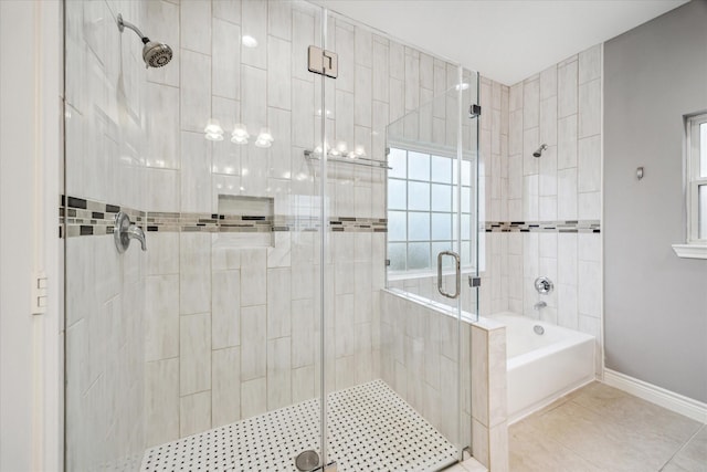 bathroom featuring tile patterned floors and separate shower and tub