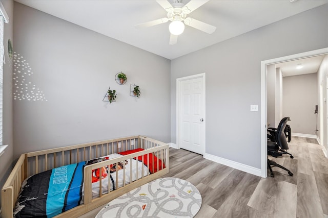 bedroom featuring ceiling fan and light hardwood / wood-style floors