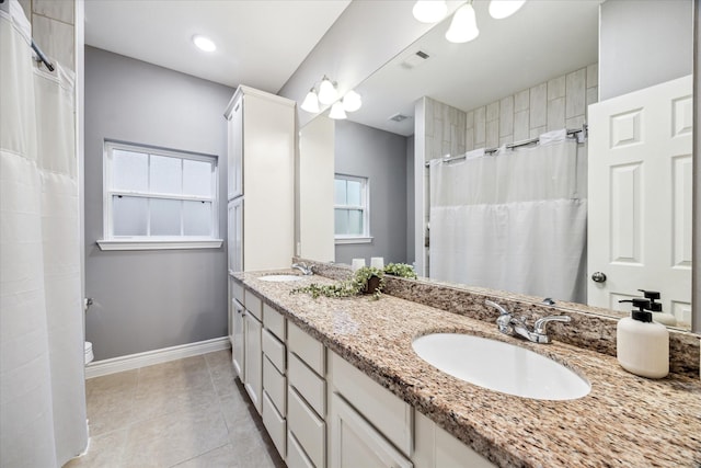 bathroom featuring curtained shower, tile patterned floors, toilet, and vanity