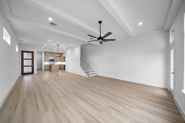 unfurnished living room featuring ceiling fan, light hardwood / wood-style floors, and beam ceiling