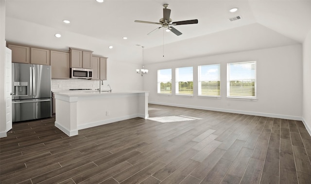 kitchen featuring ceiling fan with notable chandelier, visible vents, appliances with stainless steel finishes, backsplash, and dark wood finished floors