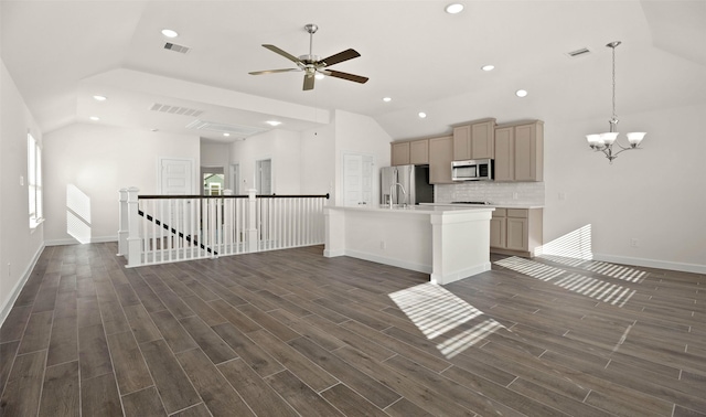 kitchen featuring lofted ceiling, appliances with stainless steel finishes, wood finish floors, and visible vents