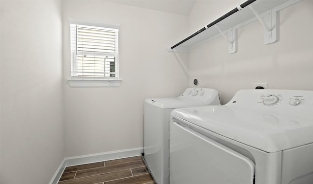 laundry room featuring laundry area, separate washer and dryer, wood finish floors, and baseboards