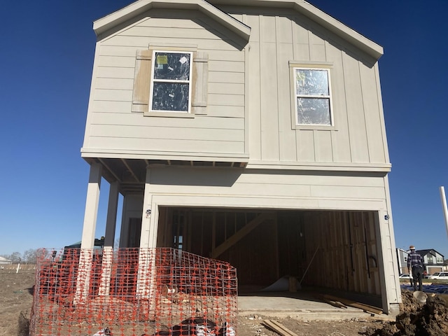 view of front facade with board and batten siding and an attached garage