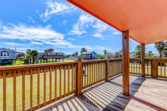 wooden terrace featuring a yard