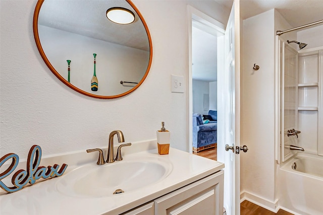 bathroom featuring tub / shower combination, hardwood / wood-style floors, and vanity