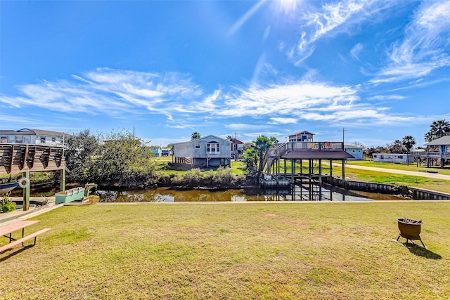 view of community with a water view and a lawn