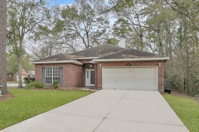 single story home featuring a front yard and a garage