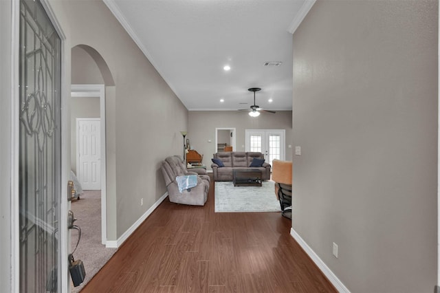 living room with ceiling fan, hardwood / wood-style floors, crown molding, and french doors