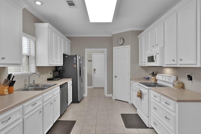 kitchen with white cabinetry, sink, and white appliances