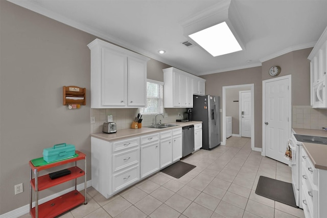 kitchen featuring backsplash, appliances with stainless steel finishes, sink, and white cabinetry