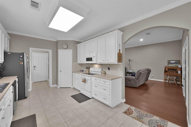 kitchen with backsplash, white appliances, white cabinetry, ornamental molding, and light tile patterned floors